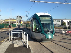 A NET Alstom Citadis tram bound for Toton Lane crosses the road onto Gregory Street, Nottingham.