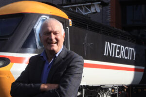 Sir Kenneth Grange at the National Railway Museum stood in front of a HST power car